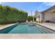 Tranquil backyard pool with lounge chairs, surrounded by lush greenery and a privacy hedge at 4708 N 41St Pl, Phoenix, AZ 85018