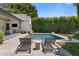 Backyard pool area with lounge chairs, shaded by an umbrella, offering a relaxing outdoor space at 4708 N 41St Pl, Phoenix, AZ 85018