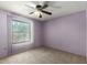 Cozy bedroom features a ceiling fan, neutral carpet, and ample natural light from the window at 4740 W Bloomfield Rd, Glendale, AZ 85304