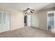 Bedroom featuring carpet flooring, ceiling fan, and access to an ensuite bathroom at 4740 W Bloomfield Rd, Glendale, AZ 85304