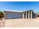 Exterior of single story home featuring a two-car garage and a covered front entry with desert landscaping at 4740 W Bloomfield Rd, Glendale, AZ 85304