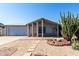 Charming single-story home featuring desert landscaping, a covered entryway, and an attached two-car garage at 4740 W Bloomfield Rd, Glendale, AZ 85304