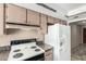 Kitchen featuring cabinets, an electric range, and a white refrigerator at 4740 W Bloomfield Rd, Glendale, AZ 85304