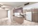 Open-concept kitchen featuring a breakfast bar, tile flooring, and white refrigerator at 4740 W Bloomfield Rd, Glendale, AZ 85304