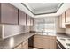 Kitchen featuring cabinets, laminate countertops, double basin sink, and electric range at 4740 W Bloomfield Rd, Glendale, AZ 85304