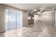Living room and kitchen area with neutral walls, tile flooring, ceiling fan, and lots of open space at 4740 W Bloomfield Rd, Glendale, AZ 85304