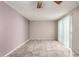 Living room with neutral walls, tile flooring, ceiling fan, and sliding glass door to allow natural light at 4740 W Bloomfield Rd, Glendale, AZ 85304
