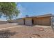 Gravel backyard featuring a covered patio and convenient access door at 5204 E Colby St, Mesa, AZ 85205