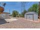 Gravel backyard with covered patio, shed, and utility pole at 5204 E Colby St, Mesa, AZ 85205