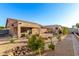 Inviting backyard with low-maintenance desert landscaping, a covered patio, and a rock water feature at 5524 E Garnet Cir, Mesa, AZ 85206