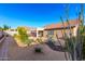 Desert-landscaped backyard with rock features and a covered patio for relaxation at 5524 E Garnet Cir, Mesa, AZ 85206