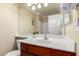 Bright bathroom featuring single sink with white countertop, and large mirror at 5524 E Garnet Cir, Mesa, AZ 85206