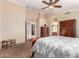 Comfortable carpeted bedroom featuring a ceiling fan, complemented by matching furniture at 5524 E Garnet Cir, Mesa, AZ 85206