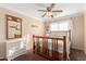 Bright bedroom featuring a ceiling fan, complemented by natural light and neutral paint at 5524 E Garnet Cir, Mesa, AZ 85206