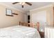 Bright bedroom featuring a ceiling fan, complemented by natural light and neutral paint at 5524 E Garnet Cir, Mesa, AZ 85206