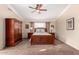 Comfortable carpeted bedroom featuring a ceiling fan, complemented by matching furniture at 5524 E Garnet Cir, Mesa, AZ 85206