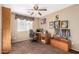 Bedroom featuring a ceiling fan, wood desk, and a window with natural light at 5524 E Garnet Cir, Mesa, AZ 85206