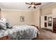 Comfortable carpeted bedroom featuring a ceiling fan, complemented by matching furniture at 5524 E Garnet Cir, Mesa, AZ 85206