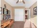 Bedroom featuring a ceiling fan, double door closet, and neutral paint at 5524 E Garnet Cir, Mesa, AZ 85206