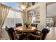 Charming dining area featuring a wood table, black chairs, and bright natural light from the window at 5524 E Garnet Cir, Mesa, AZ 85206