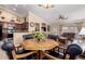 Open-concept dining area with wood table and black chairs, seamlessly connecting to the kitchen and living spaces at 5524 E Garnet Cir, Mesa, AZ 85206