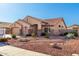 Well-maintained home boasting desert landscaping, a three-car garage, and inviting curb appeal in a lovely neighborhood at 5524 E Garnet Cir, Mesa, AZ 85206