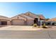 Charming single-story home featuring a three car garage, desert landscaping, and a welcoming front entrance at 5524 E Garnet Cir, Mesa, AZ 85206