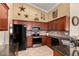 Well-equipped kitchen showcasing wood cabinets, granite countertops, and modern stainless steel appliances at 5524 E Garnet Cir, Mesa, AZ 85206
