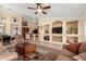 Inviting living room boasts neutral tones, ceiling fan, and built-in shelving, perfect for relaxation and entertainment at 5524 E Garnet Cir, Mesa, AZ 85206