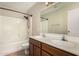 Bathroom featuring double vanity sinks, a tub/shower combo, and sleek fixtures at 6317 E Colby St, Mesa, AZ 85205