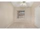 Cozy bedroom with tiled flooring, a ceiling fan, and a large window at 6317 E Colby St, Mesa, AZ 85205
