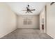 Bedroom with neutral carpet, a ceiling fan, and a window, creating a comfortable living space at 6317 E Colby St, Mesa, AZ 85205