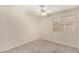 Bright bedroom featuring neutral carpeting, a ceiling fan, and a window offering natural light at 6317 E Colby St, Mesa, AZ 85205