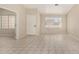 Spacious living room featuring neutral walls, tile flooring, a large window, and front door at 6317 E Colby St, Mesa, AZ 85205