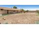 Backyard featuring a large dirt yard with a block wall, plants and trees at 6426 W Mulberry Dr, Phoenix, AZ 85033