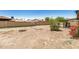 Backyard featuring a large dirt yard with a block wall, plants and trees at 6426 W Mulberry Dr, Phoenix, AZ 85033
