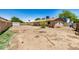 Backyard featuring a large dirt yard with a block wall, plants and trees at 6426 W Mulberry Dr, Phoenix, AZ 85033