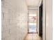 Hallway view with white brick walls and a view of the outdoors at 6426 W Mulberry Dr, Phoenix, AZ 85033