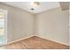 Smaller room featuring wood floors, neutral walls, and a door that leads to the backyard at 6426 W Mulberry Dr, Phoenix, AZ 85033