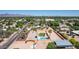 Aerial view of a home with a pool and grassy backyard in a desert neighborhood with mountain views at 7101 E Cholla St, Scottsdale, AZ 85254