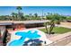 Inviting backyard with a unique pool, grassy area, patio with seating and fully enclosed for privacy at 7101 E Cholla St, Scottsdale, AZ 85254