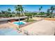 Inviting backyard with a unique pool, grassy area, patio with seating and fully enclosed for privacy at 7101 E Cholla St, Scottsdale, AZ 85254