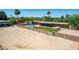 Inviting backyard with a unique pool, grassy area, patio with seating and fully enclosed for privacy at 7101 E Cholla St, Scottsdale, AZ 85254