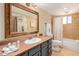 Bathroom featuring a single sink, dark cabinets and a shower/tub combo at 7101 E Cholla St, Scottsdale, AZ 85254