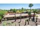 Charming single-story home with lush palm trees, a covered patio and mountain views at 7101 E Cholla St, Scottsdale, AZ 85254