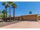 Ranch-style home features a low-pitched roof, desert landscaping and a two-car garage at 7101 E Cholla St, Scottsdale, AZ 85254