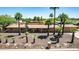 Single-story home with mature palm trees, a desert landscape, and a welcoming entrance at 7101 E Cholla St, Scottsdale, AZ 85254