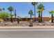 Single-story home with desert landscaping, mature palm trees, and a quaint entryway at 7101 E Cholla St, Scottsdale, AZ 85254