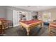 Spacious game room includes a pool table and opens to the kitchen through french doors at 7101 E Cholla St, Scottsdale, AZ 85254