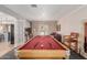 Game room with a pool table, exposed brick wall, and access to the outdoor living space at 7101 E Cholla St, Scottsdale, AZ 85254